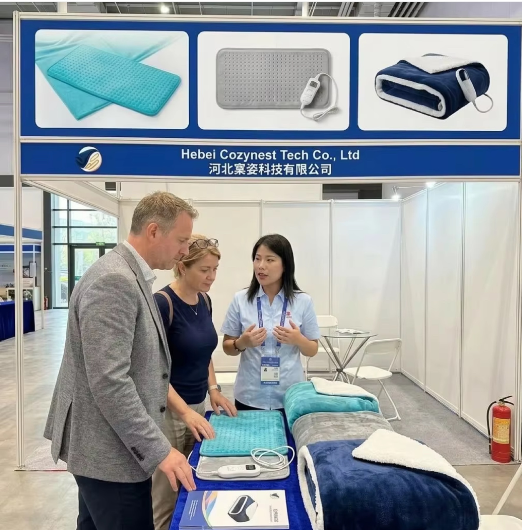 Cozynest representatives presenting heating textile products at a trade show
